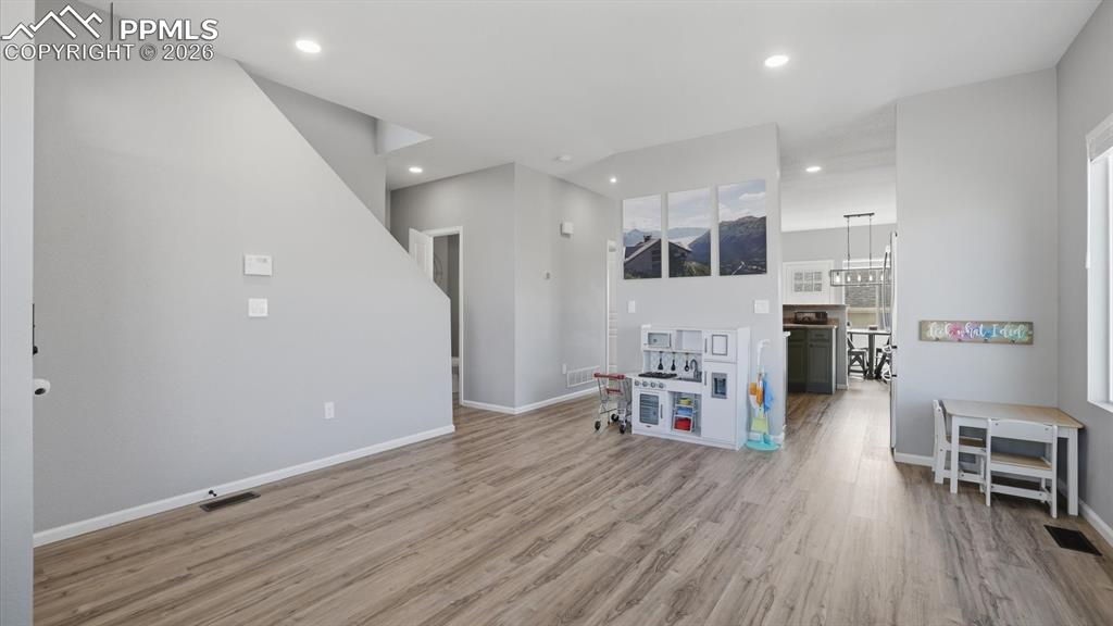 Image 8 of 50: The Living Room flows seamlessly into the Family Room and Kitchen.