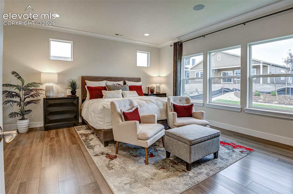 Image 15 of 31: Wood-finish flooring, recessed lighting, multiple windows, built-in ceiling