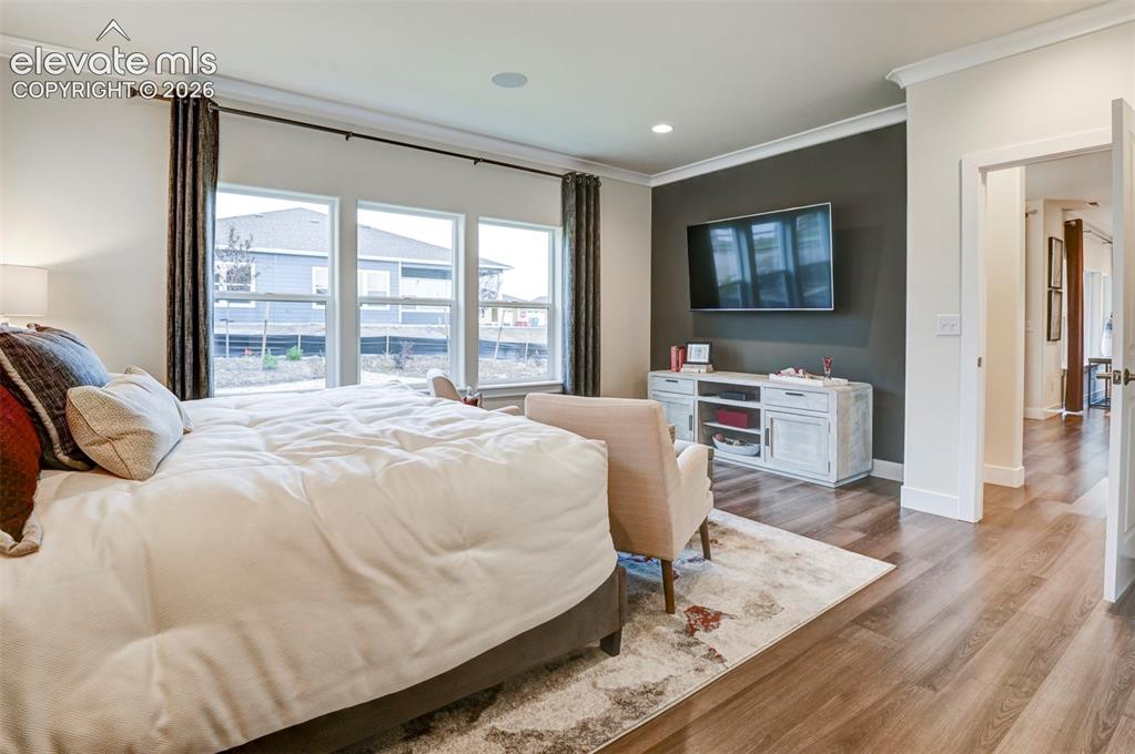 Image 17 of 31: Wood-finish flooring throughout, ceiling crown molding, recessed lighting, 