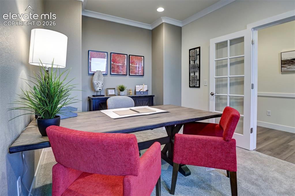 Image 2 of 31: Office space featuring crown molding, recessed lighting, and a glass-panele