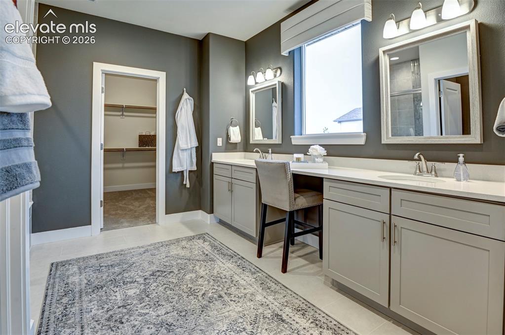 Image 23 of 31: Dual vanity with light gray cabinetry, light countertops, and individual mi