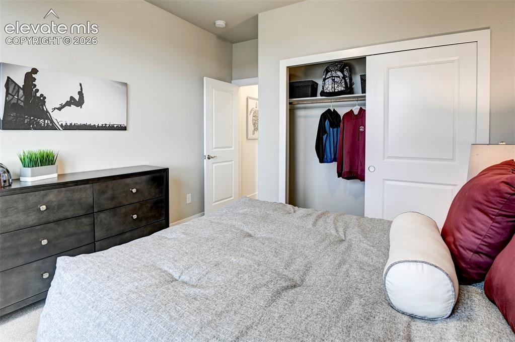 Image 25 of 31: Recessed lighting, wood-finish dresser with metal hardware, and a built-in 