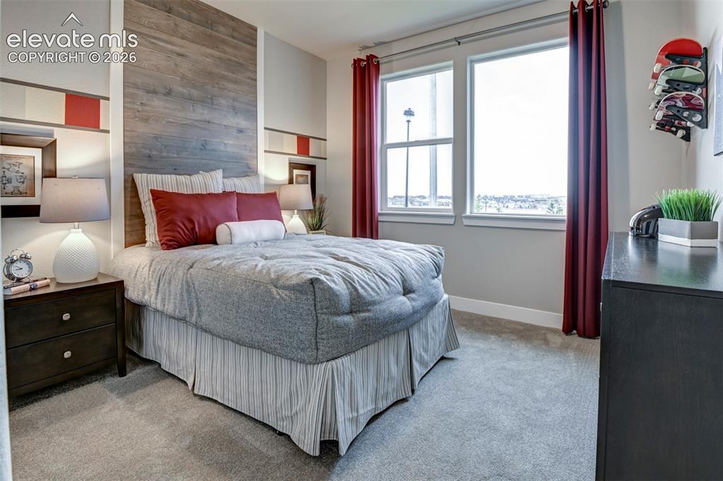 Image 26 of 31: Recessed paneling with wood-finish accent wall, built-in shelving, two wind