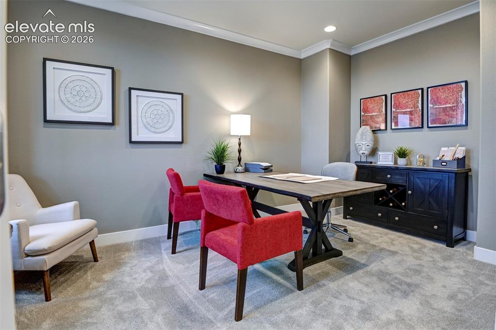 Image 3 of 31: Recessed lighting illuminates a space featuring crown molding, neutral wall