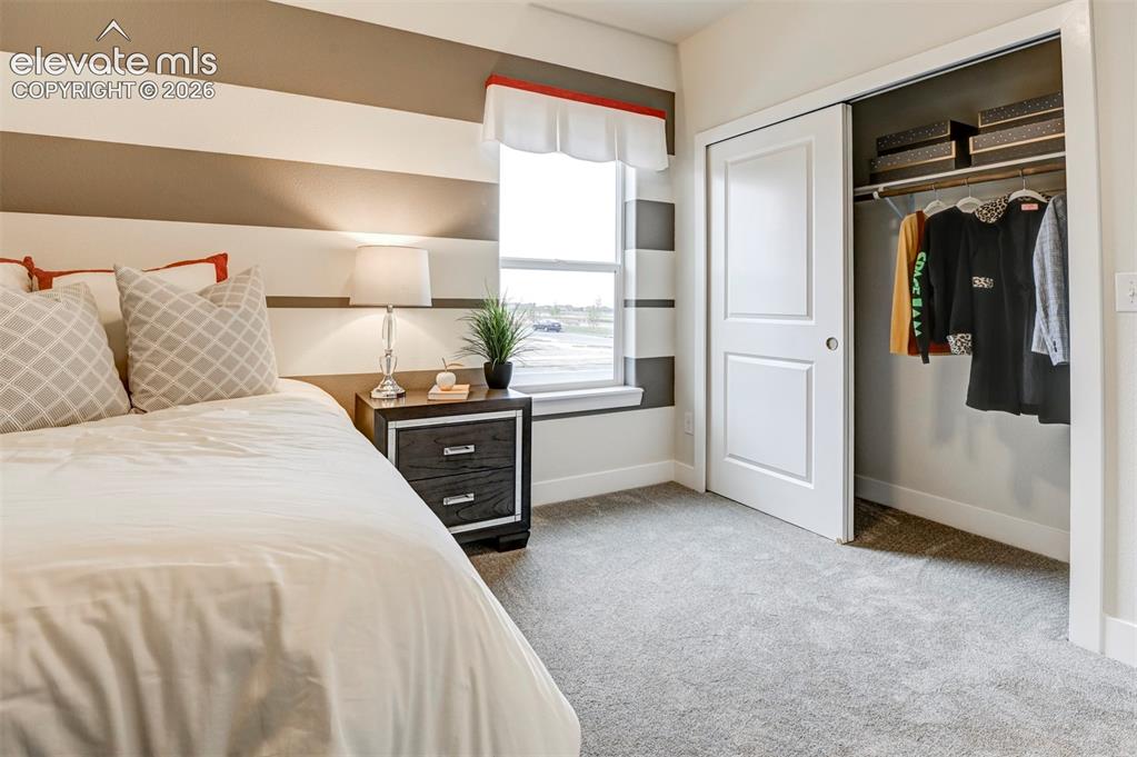 Image 30 of 31: Wall-to-wall carpeting, window with a window ledge, sliding closet doors, a