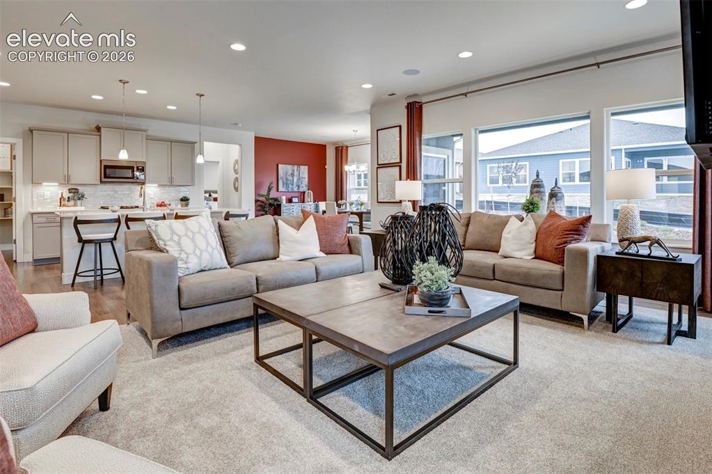 Image 7 of 31: Open-concept living space featuring recessed lighting, a kitchen island wit