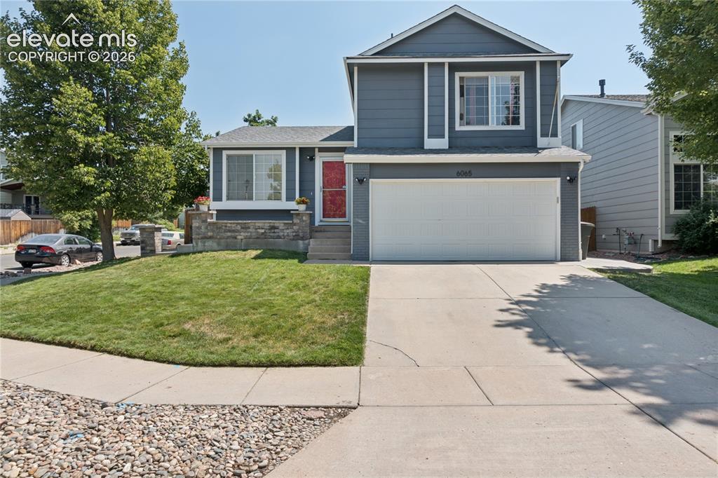 Image 1 of 31: Two-story residence with a two-car garage, concrete driveway, and a front l