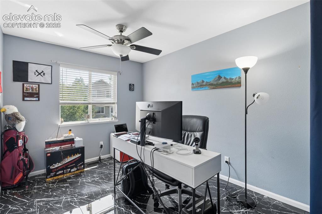 Image 16 of 31: Room featuring black marble-finish flooring, a ceiling fan with integrated
