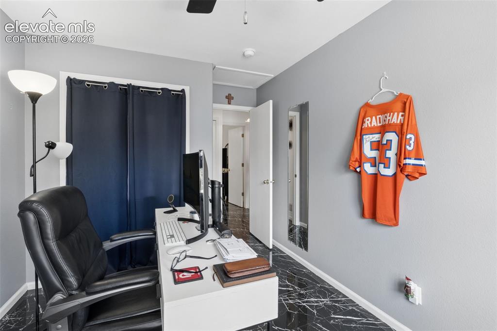 Image 17 of 31: Black marble-finish flooring, light grey painted walls, white door frames,