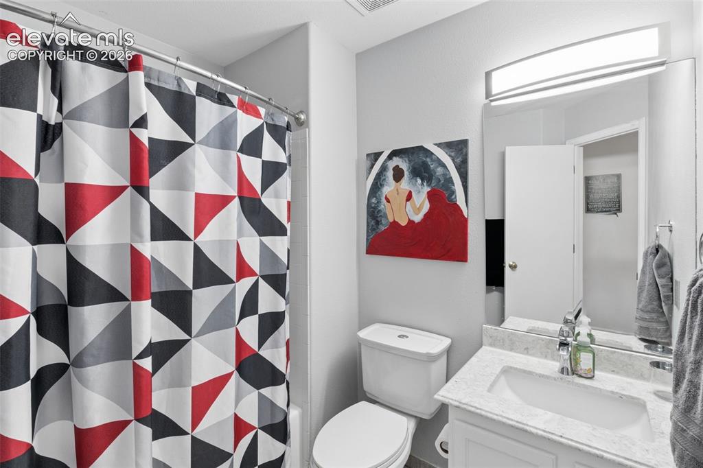 Image 19 of 31: Vanity with integrated sink, polished chrome faucet, and stone countertop