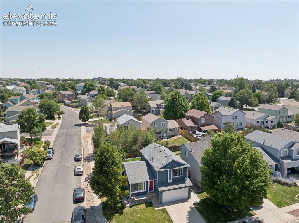 Image 25 of 31: Two-story home with an attached garage, featuring a shingled roof and a fro