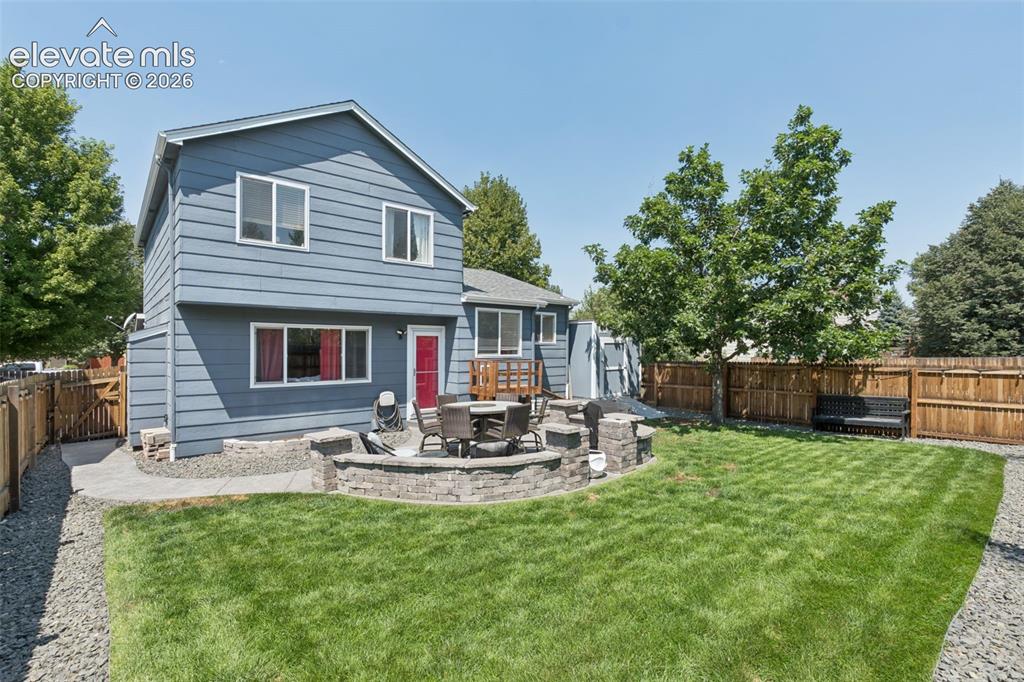 Image 28 of 31: Expansive backyard featuring a manicured lawn, established perimeter fencin