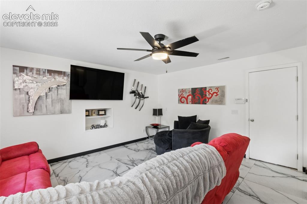 Image 8 of 31: White walls, black-and-white veined flooring, recessed wall niche, and a ce