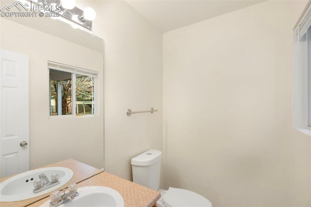 Image 13 of 31: Half bath with vanity and toilet