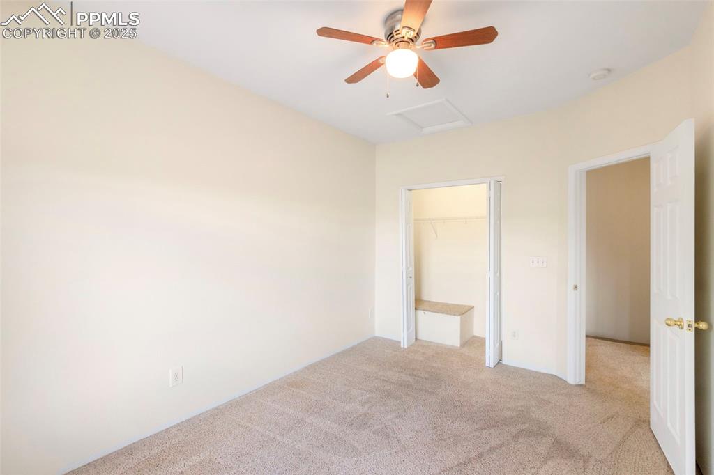 Image 15 of 31: Unfurnished bedroom featuring carpet flooring, a spacious closet, attic acc
