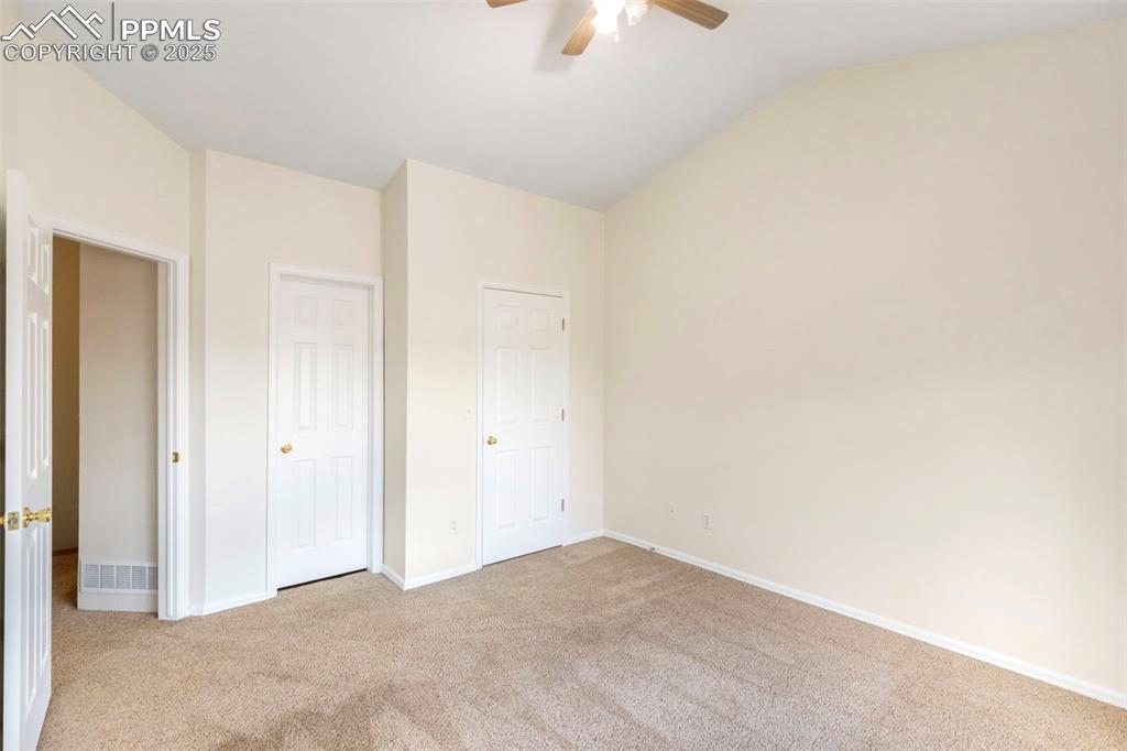 Image 20 of 31: Unfurnished bedroom featuring light colored carpet, lofted ceiling, ceiling
