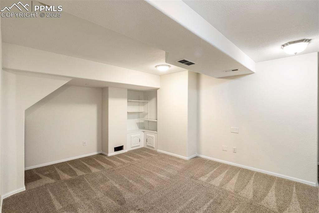 Image 25 of 31: Finished below grade area featuring carpet and baseboards