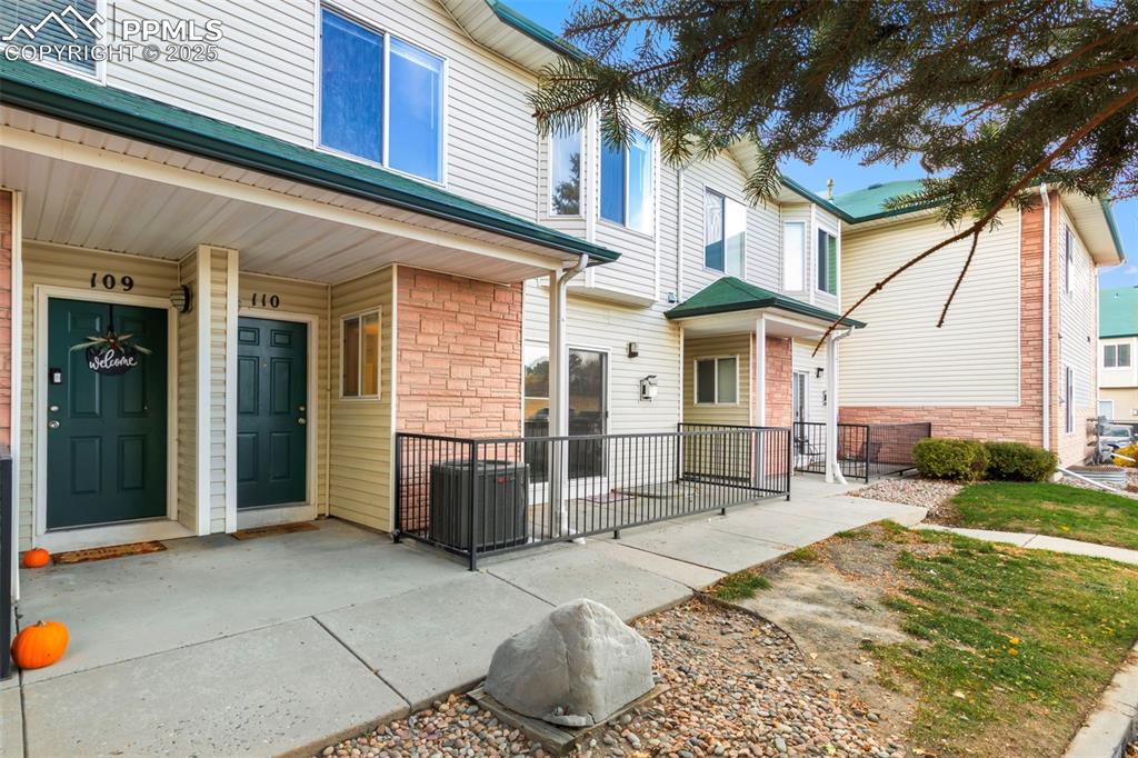 Image 3 of 31: Property entrance with a porch and stone siding
