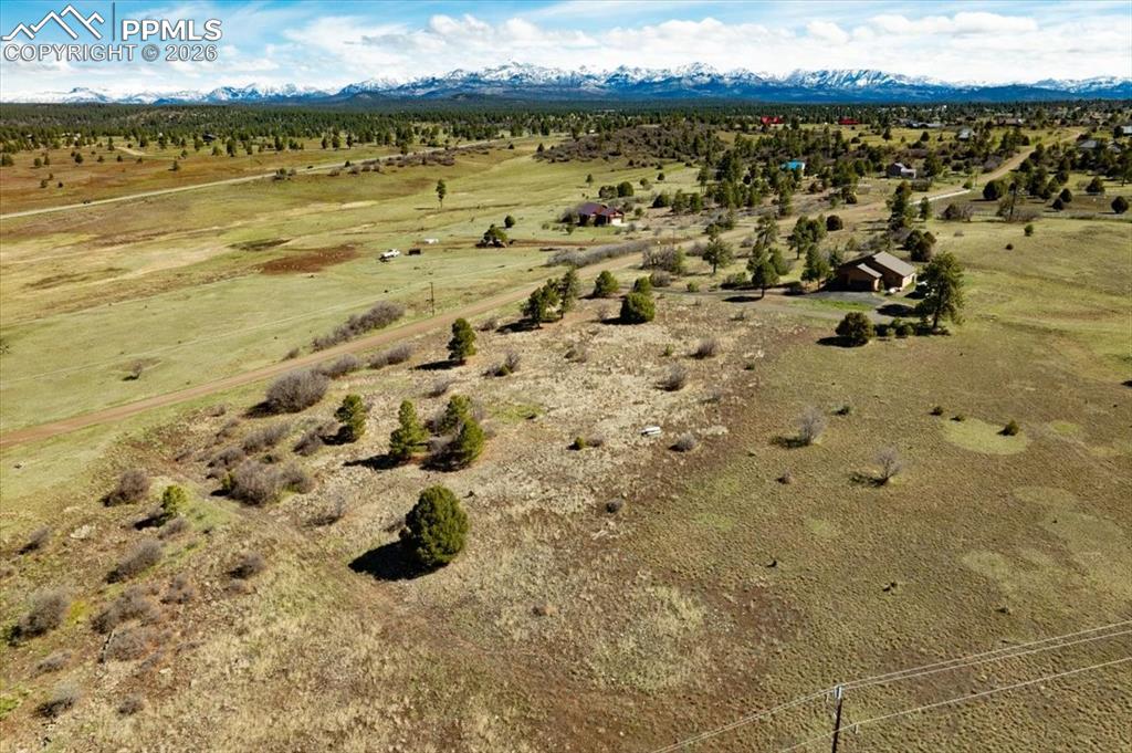 Image 11 of 31: Aerial view of sparsely populated area with mountains