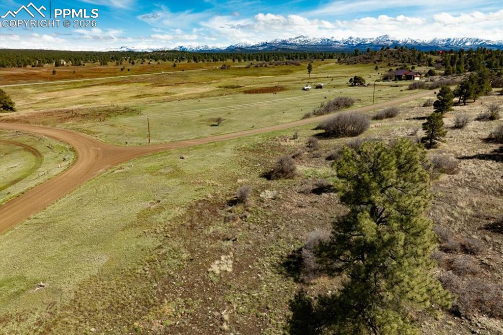 Image 13 of 31: Aerial view of sparsely populated area with a mountainous background
