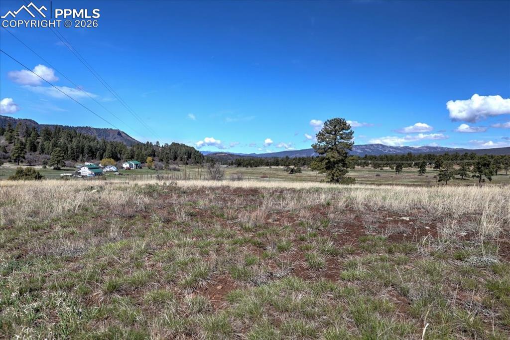 Image 19 of 31: View of mountain backdrop with rural landscape