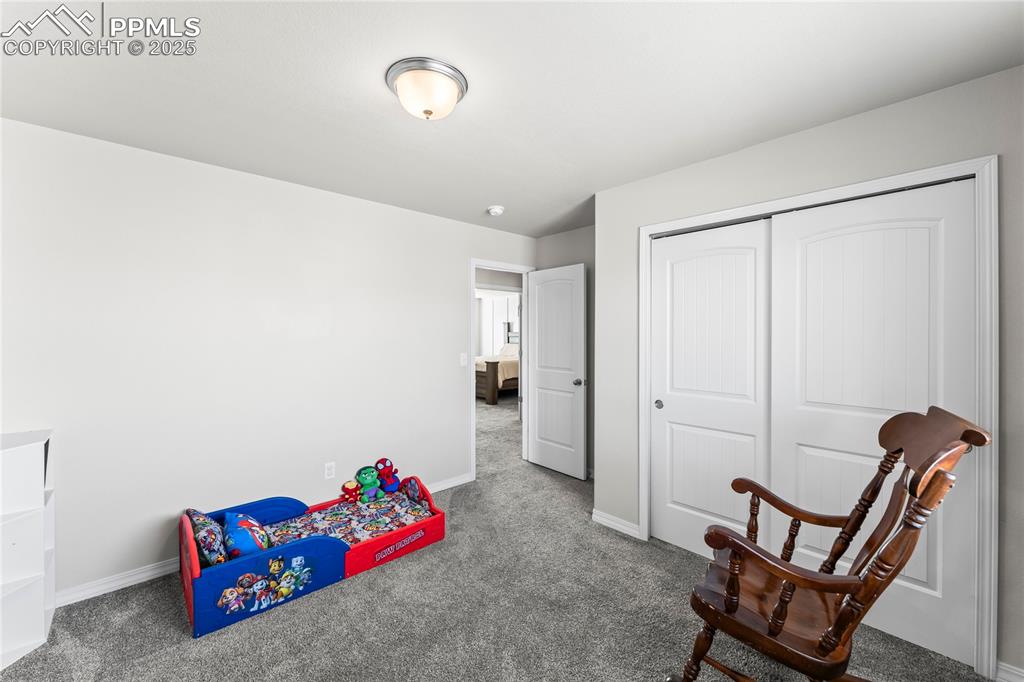 Image 28 of 40: Game room featuring carpet floors and baseboards