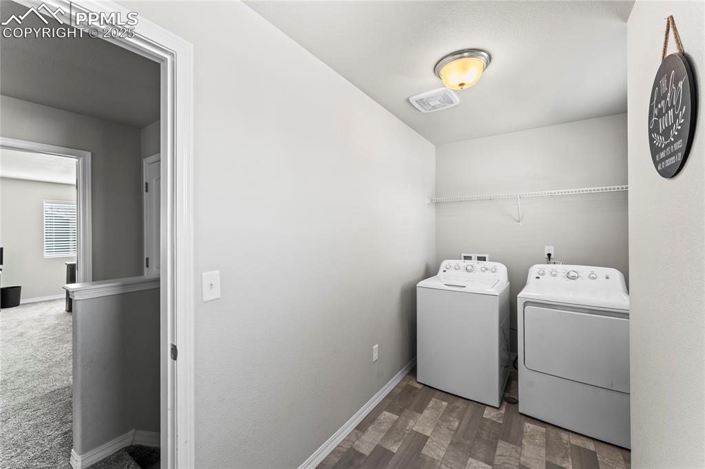 Image 34 of 40: Washroom featuring independent washer and dryer and wood finished floors