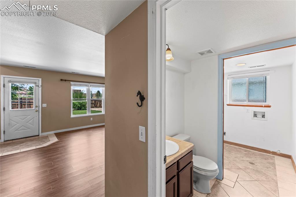 Image 17 of 42: Bathroom featuring healthy amount of natural light, a textured ceiling, van