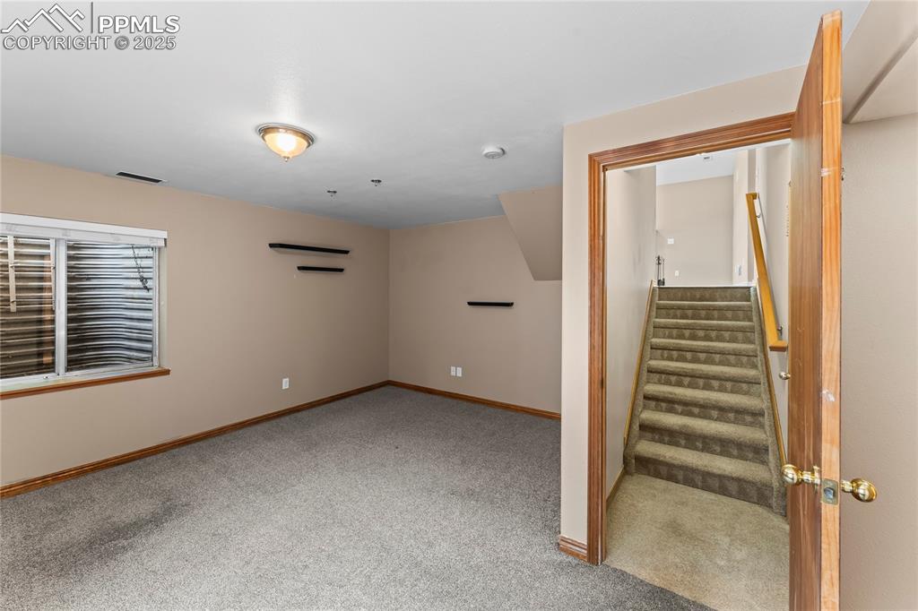 Image 20 of 42: Stairway featuring carpet flooring and baseboards