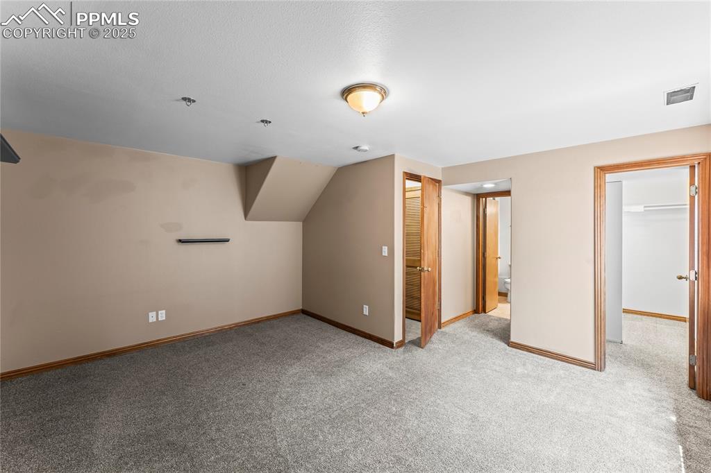 Image 21 of 42: Additional living space featuring light colored carpet and baseboards