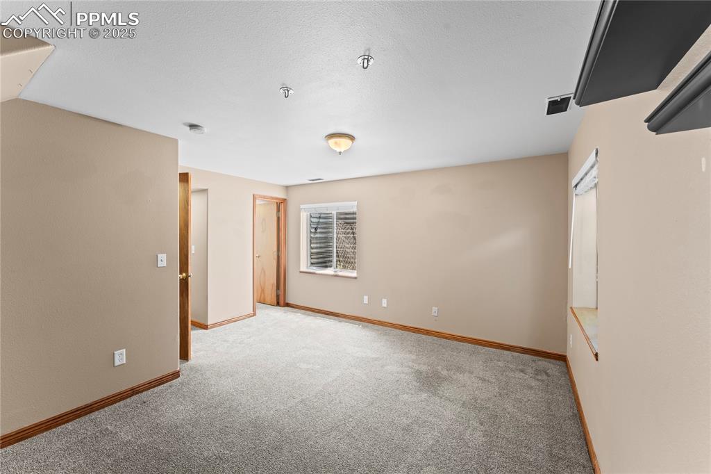 Image 22 of 42: Empty room featuring carpet flooring and a textured ceiling