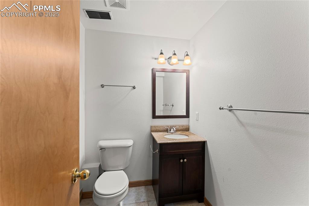 Image 23 of 42: Half bath featuring vanity and tile patterned flooring