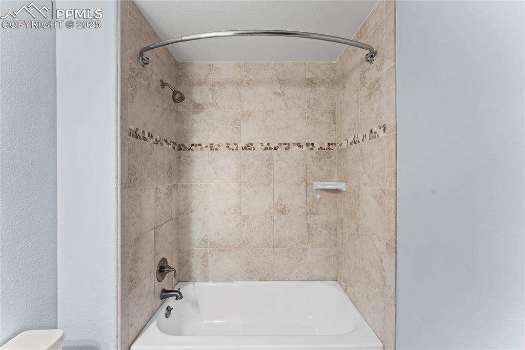 Image 29 of 42: Full bathroom with toilet and tub / shower combination