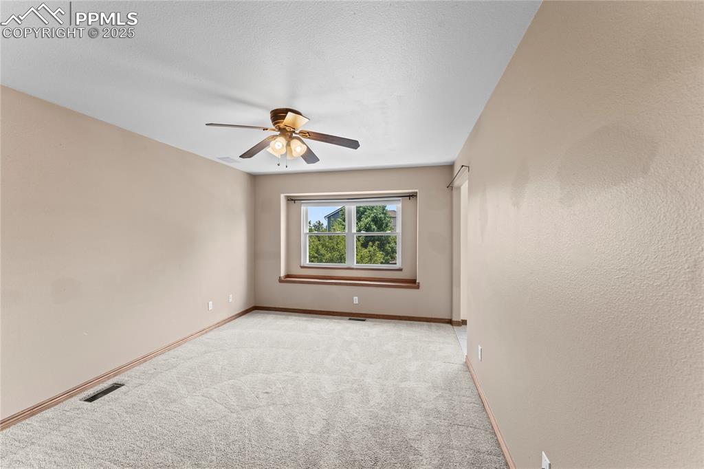 Image 34 of 42: Unfurnished room featuring light colored carpet and ceiling fan