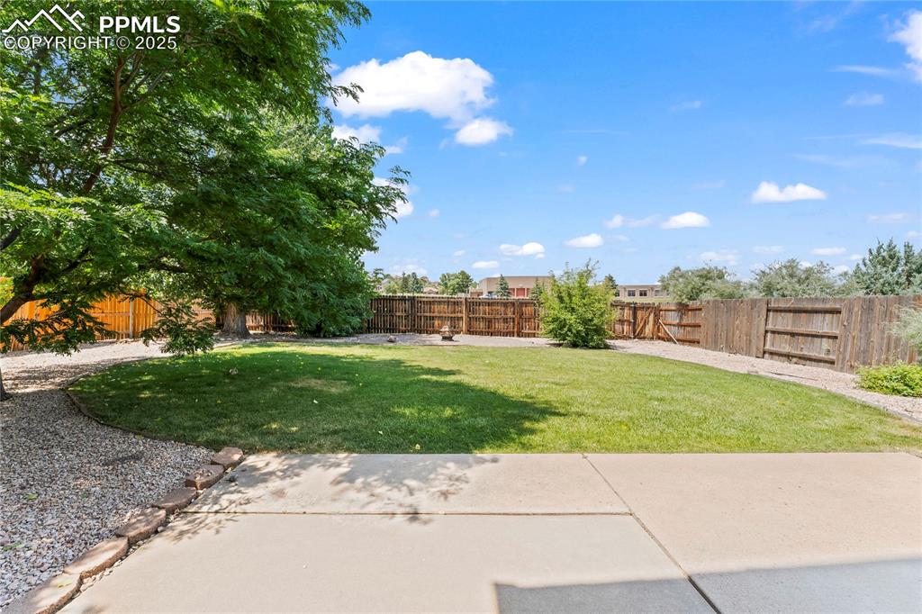 Image 39 of 42: Fenced backyard featuring a patio area