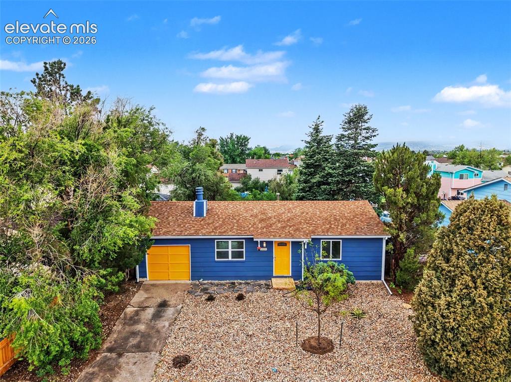 Image 1 of 43: Vibrant blue exterior with a contrasting yellow garage door and front door