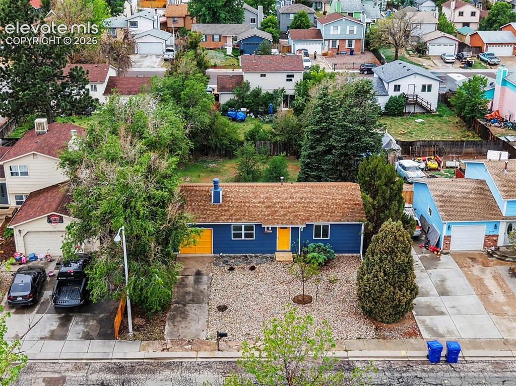 Image 2 of 43: Blue exterior siding featuring a bright yellow front door and garage door