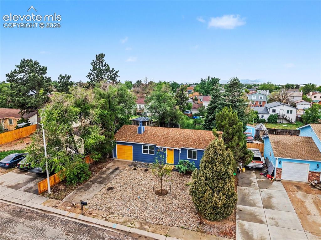 Image 3 of 43: Blue exterior residence with a brown shingle roof, featuring a detached sin