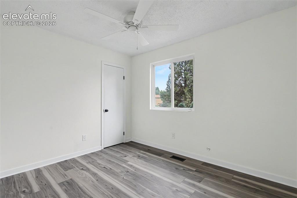 Image 34 of 43: Interior space featuring wood-finish flooring, white walls, and a white cei