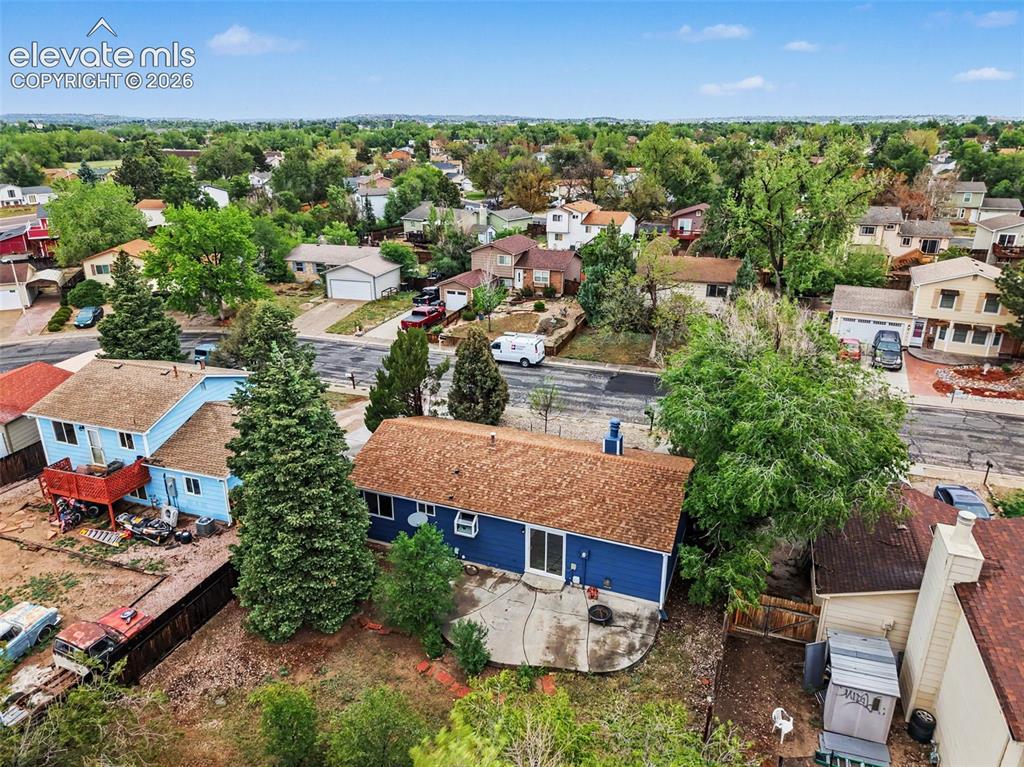 Image 6 of 43: Residential property featuring a blue exterior, a brown shingle roof, a rea
