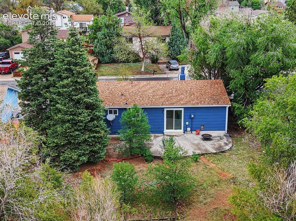 Image 8 of 43: Blue exterior with a brown shingle roof