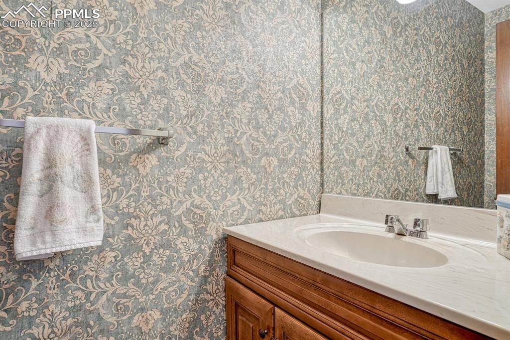 Image 19 of 46: A half bathroom on the main floor offers a touch of elegance with its sleek