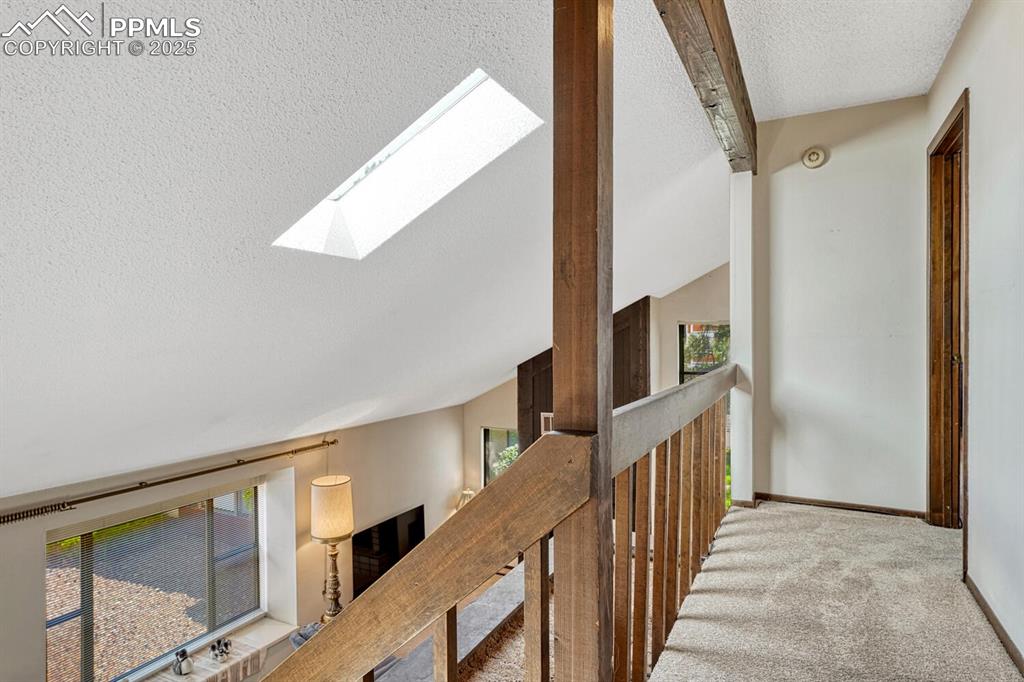 Image 20 of 32: Carpeted bedroom with a textured ceiling and baseboards