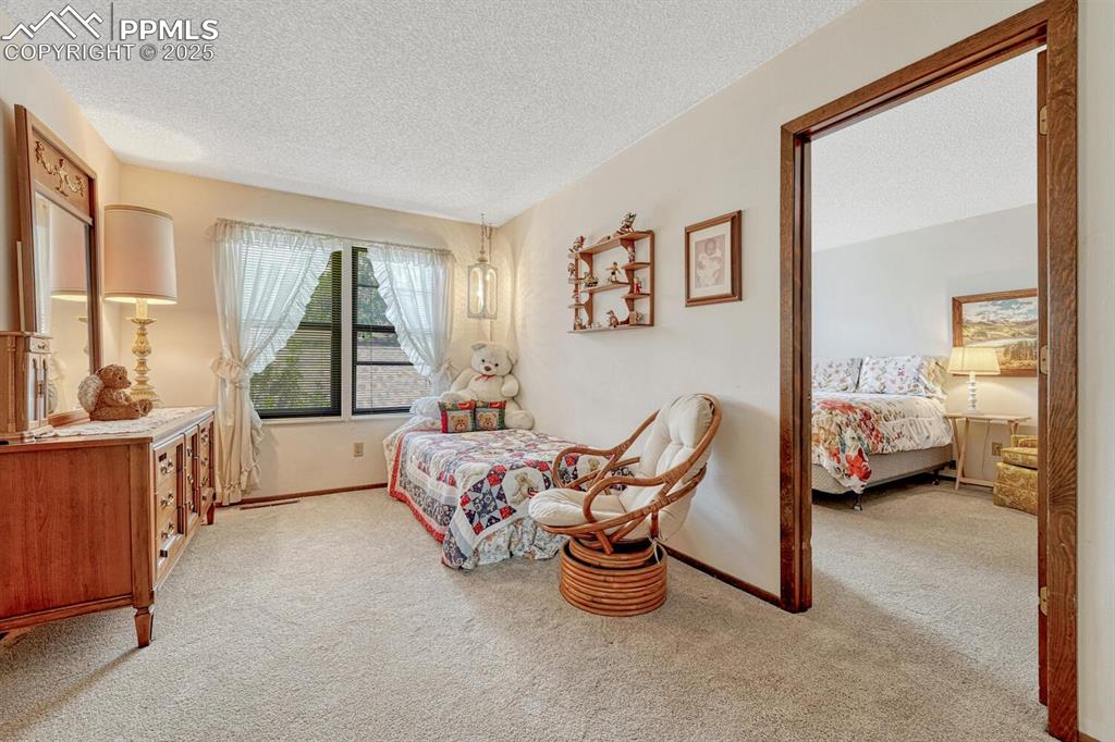 Image 27 of 46: Bedroom, with a soft, light-colored carpet creates a haven of warmth and co