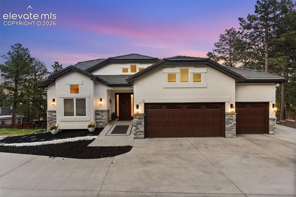 Image 3 of 48: Contemporary stucco exterior with stone accents