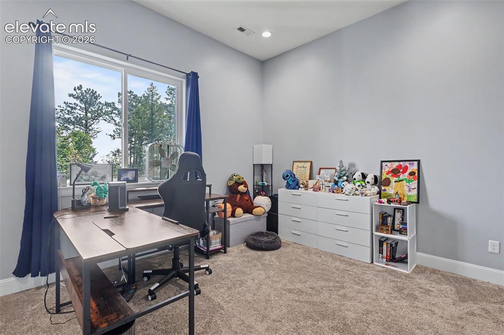 Image 42 of 48: Expansive room featuring a large window, recessed lighting, neutral wall pa