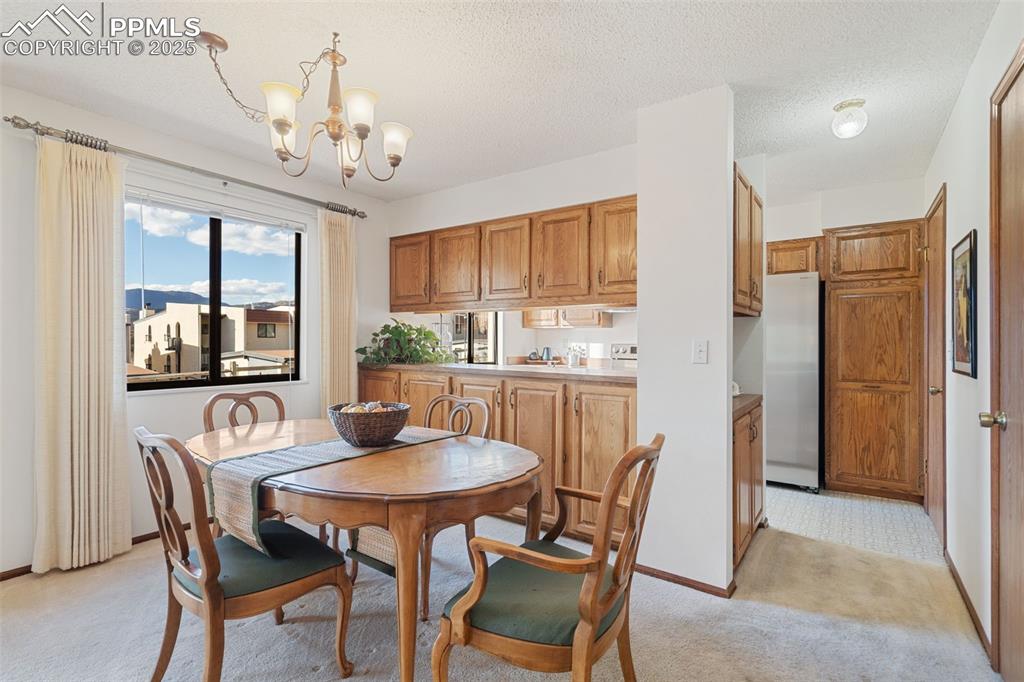 Image 11 of 28: The dining area, which is open to the kitchen, features a wall of storage c