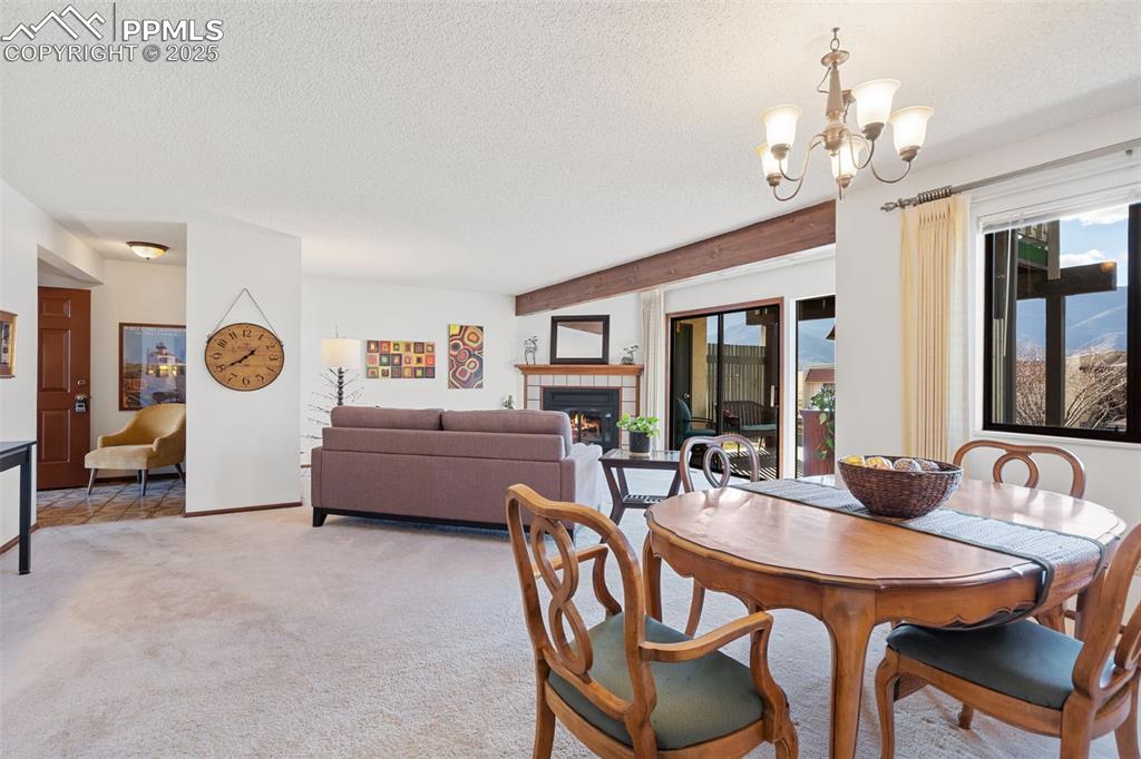 Image 12 of 28: A view of the living room and entry from the dining area.