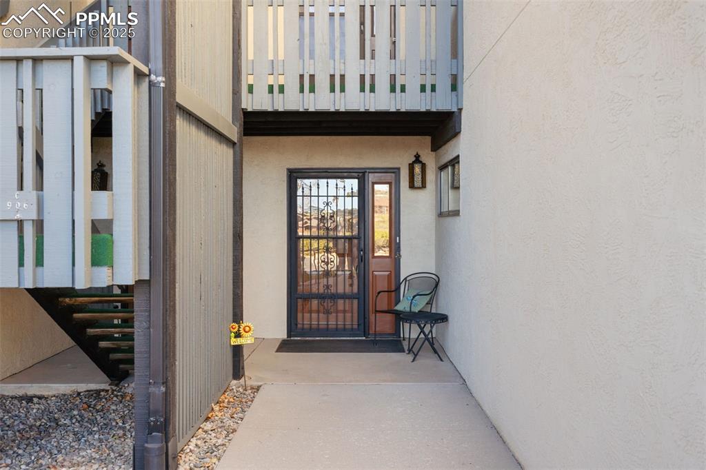Image 2 of 28: The covered entry to the condo is set back from the street.