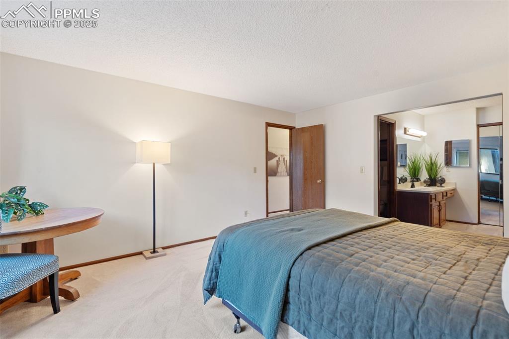 Image 22 of 28: The primary suite includes a full bath with dressing area.